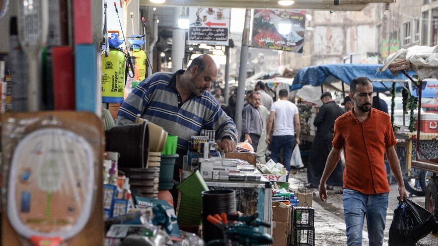An Iraqi vendor organises his stall in Mosul, part of Nineveh province where unemployment is around 40 percent