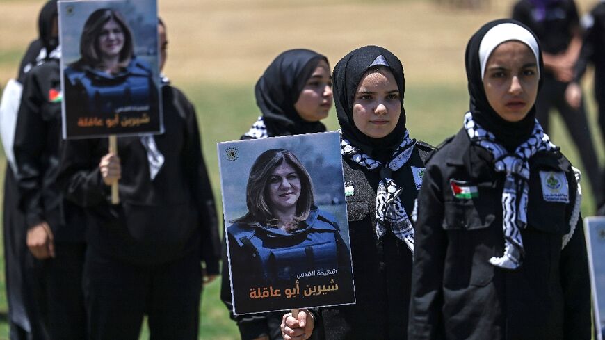 Palestinian youths hold a mock funeral for slain Al Jazeera reporter Shireen Abu Akleh in Gaza City on May 17, 2022