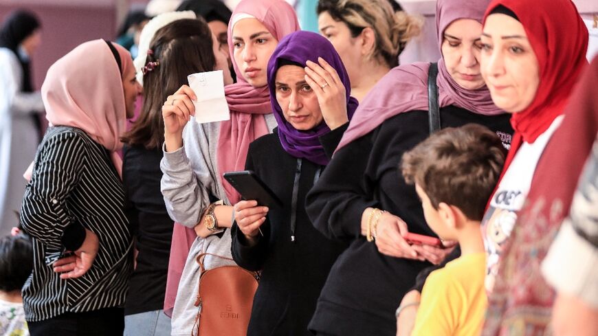 Lebanese women line up to vote for the parliamentary election at a polling station in the capital Beirut's southern suburbs, on May 15, 2022