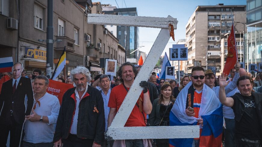 A man at the Belgrade march carried a large letter 'Z', the mark of Russia's invasion of Ukraine