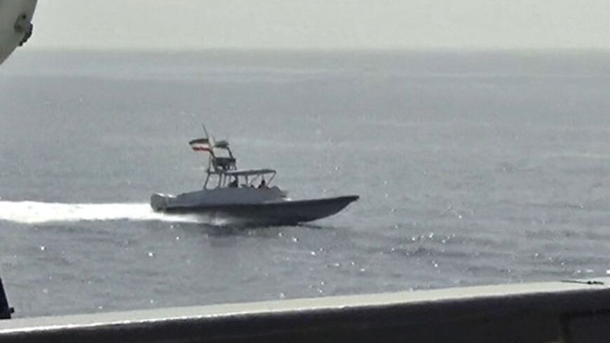 A photo released on June 20, 2022 by the US Defense Visual Information Distribution Service shows a boat of Iran's Islamic Revolutionary Guard Corps Navy in close proximity to patrol coastal ship USS Sirocco 