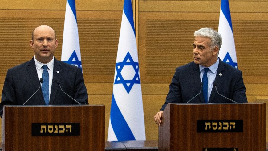 Israel's Prime Minister Naftali Bennett (L) and Foreign Minister Yair Lapid make a joint statement to the press in Jerusalem