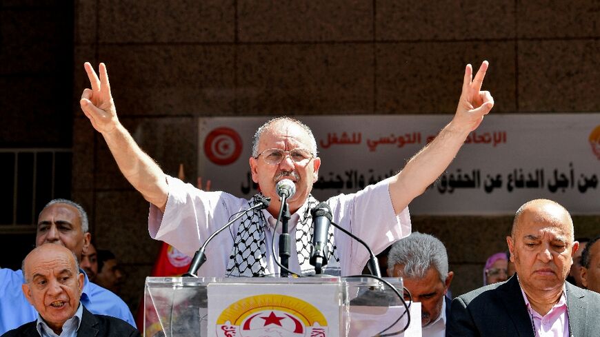 UGTT chief Noureddine Taboubi adddresses strike supporters gathered outside the trade union confederation's headquarters in Tunis