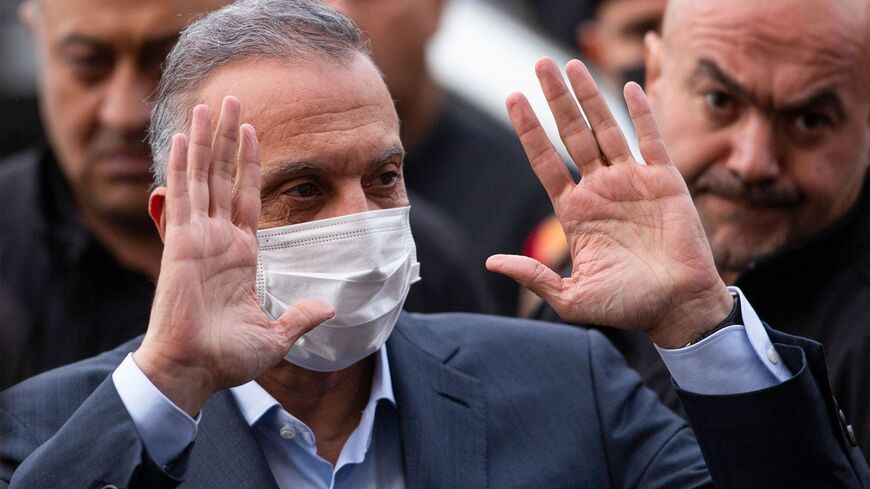 Iraq's Prime Minister Mustafa Kadhimi arrives to attend a memorial service for the victims of a motorcycle bomb that exploded the day before, in the southern city of Basra on Dec. 8, 2021. 