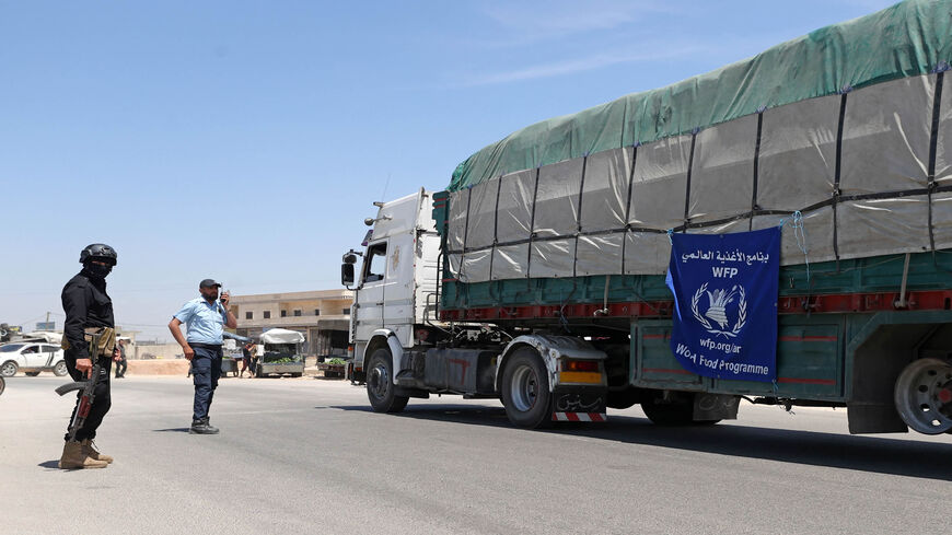 A truck carrying aid packages from the World Food Program drives through the town of Hazano in the rebel-held northern countryside of Idlib province, Syria, May 16, 2022.