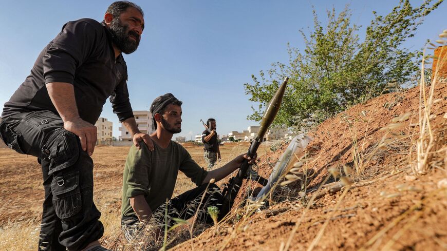 A Turkish-backed Syrian rebel fighter holds a rocket-propelled grenade launcher.