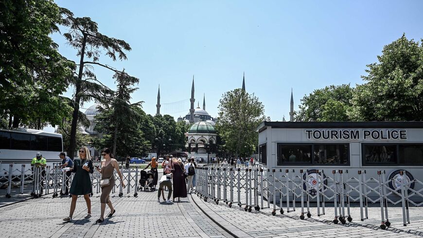 Tourists pass through a police checkpoint in Istanbul.