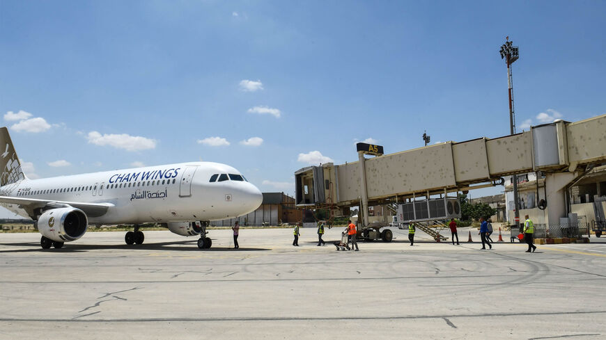 A Cham Wings Airlines Airbus A320-211 is pictured at the Aleppo airport after flights were diverted from Damascus aiport following an airstrike that damaged the airport, Syria, June 15, 2022.