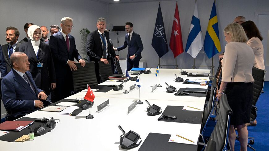 Turkey's President Recep Tayyip Erdogan (L), NATO Secretary-General Jens Stoltenberg (C) and Sweden's Prime Minister Magdalena Andersson.