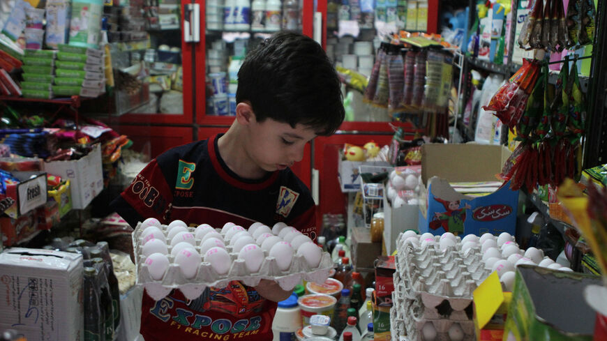An Iranian boy takes a tray of eggs at a grocery store in Tehran on Sept. 30, 2012.