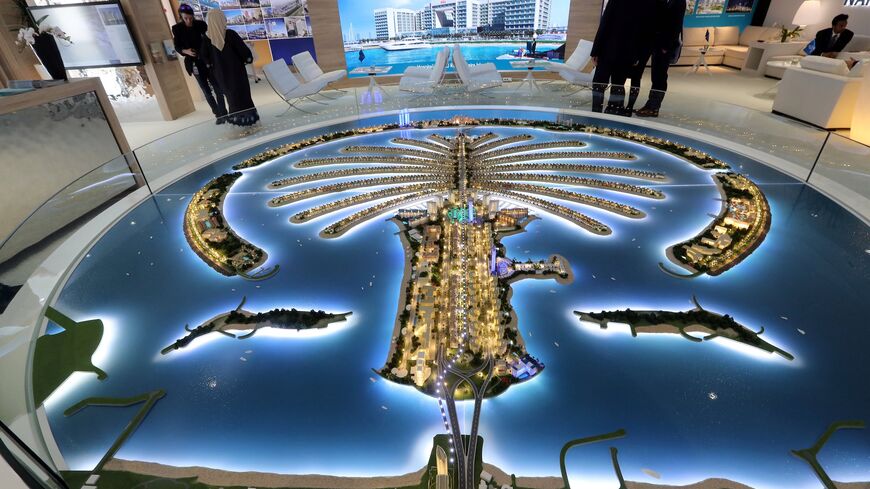 Visitors look at a scale model of the city of Dubai.