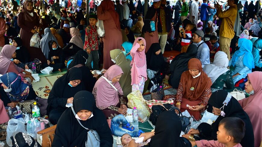 People gather to see off their relatives en-route to Mecca in Saudi Arabia for the annual Hajj pilgrimage, from the Narathiwat provincial airport in southern Thailand on June 10, 2022