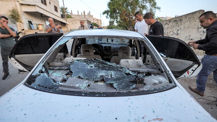 People inspect a bullet-riddled vehicle where three Palestinians were killed in an operation by Israeli forces in Jenin in the occupied West Bank