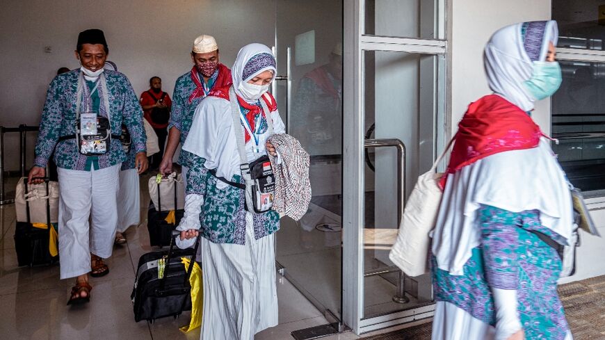 Indonesians prepare to depart from Juanda International Airport in Surabaya, as part of the first batch of hajj pilgrims since before the coronavirus pandemic