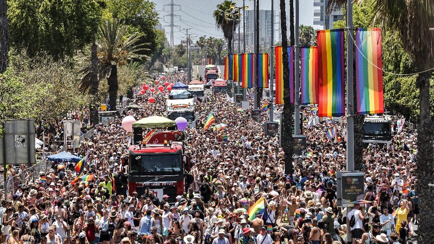 Revellers in colourful outfits celebrated in the sweltering heat, waving rainbow flags and dancing to electronic music as floats slowly drove through the streets of Tel Aviv