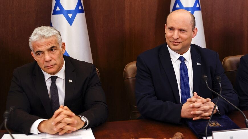 Israeli Prime Minister Naftali Bennett (R) and  Foreign Minister Yair Lapid attend a cabinet meeting ahead of parliament's expected dissolution 