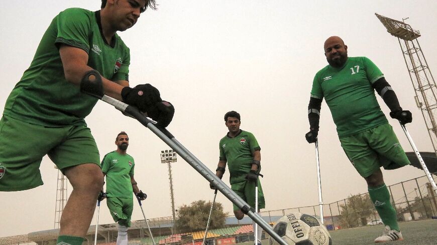 Members of the Iraqi national football team for amputees take part in a training session at Al-Shaab stadium in Baghdad
