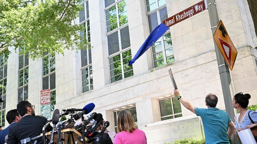 A street sign for Jamal Khashoggi Way is unveiled during outside the embassy of Saudi Arabia in Washington