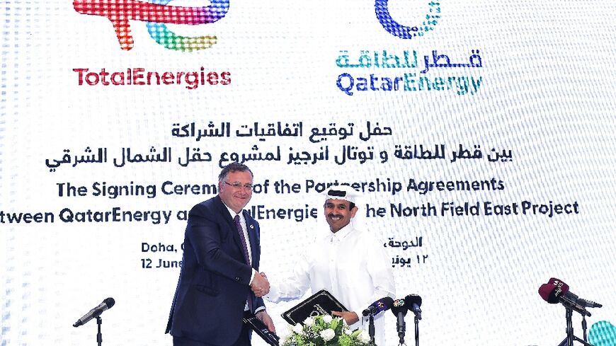 Qatar's Energy Minister and CEO of QatarEnergy Saad Sherida al-Kaabi (R) and French energy group TotalEnergies CEO Patrick Pouyanne attend a signing ceremony in Doha 