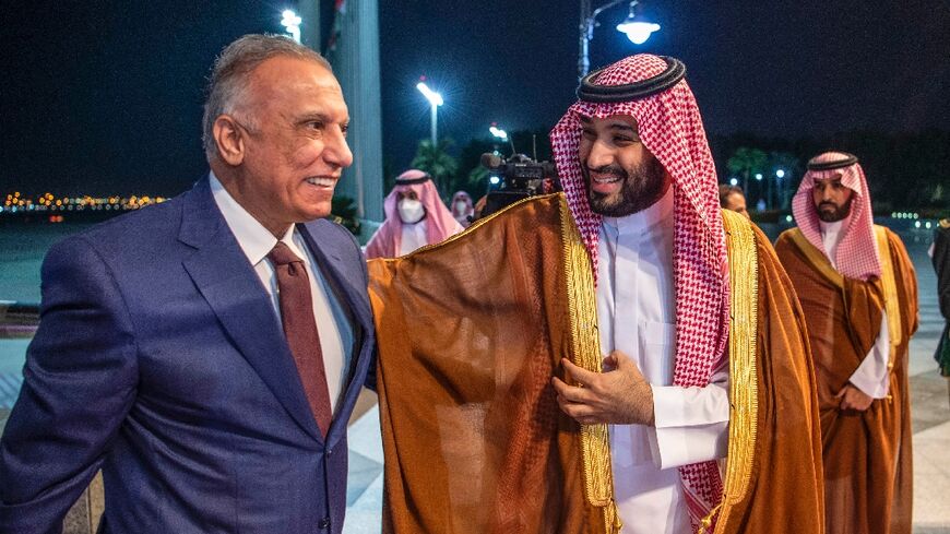 Saudi Crown Prince Mohammed bin Salman (R) receives Iraqi Prime Minister Mustafa al-Kadhemi at the airport in the Red Sea city of Jeddah