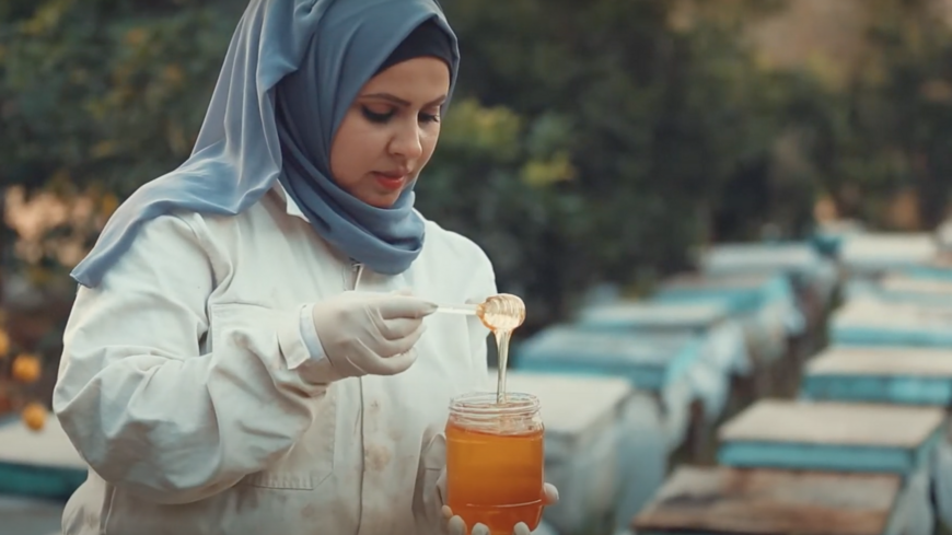 Samar al-Baa inspects honey collected from her beehives in Beit Hanoun, Gaza Strip, in a still from a video uploaded May 30, 2021. 