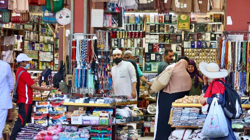 Muslim pilgrims shop at a market in Mecca -- the hajj is welcoming its first international visitors since 2019