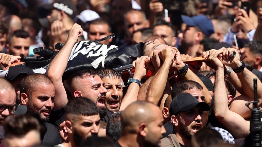 Mourners carry the body of one of two Palestinians killed overnight in confrontations with Israeli troops in the  the occupied West Bank city of Nablus