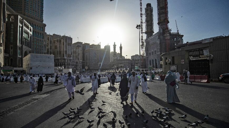Pilgrims, pictured outside the Grand Mosque in Mecca, say they are enduring the heat because of their faith in God