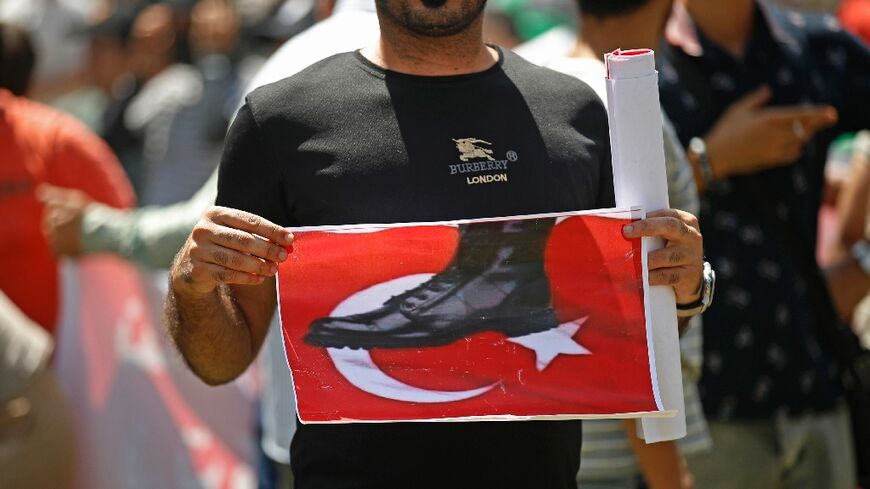 An Iraqi takes part in a demonstration in Baghdad against an attack on the country's autonomous Kurdistan region blamed on Turkey