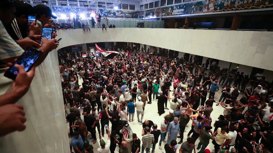 Supporters of Iraqi cleric Moqtada Sadr gather inside  Iraq's parliament in Baghdad's high-security Green Zone on Wednesday night