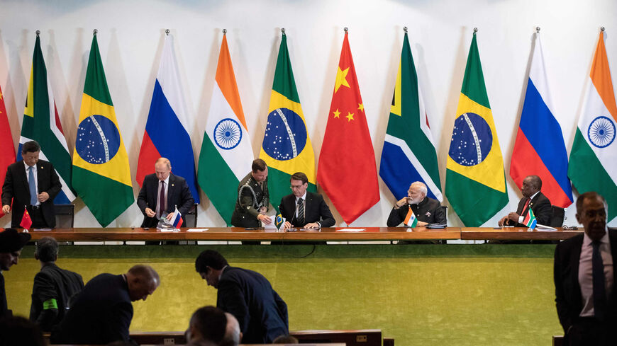 China's President Xi Jinping (L), Russia's President Vladimir Putin (2nd L), Brazil's President Jair Bolsonaro (C), India's Prime Minister Narendra Modi (2nd R) and South Africa's President Cyril Ramaphosa (R) attend a meeting with members of the Business Council and management of the New Development Bank during the BRICS Summit in Brasilia, Brazil, Nov. 14, 2019.