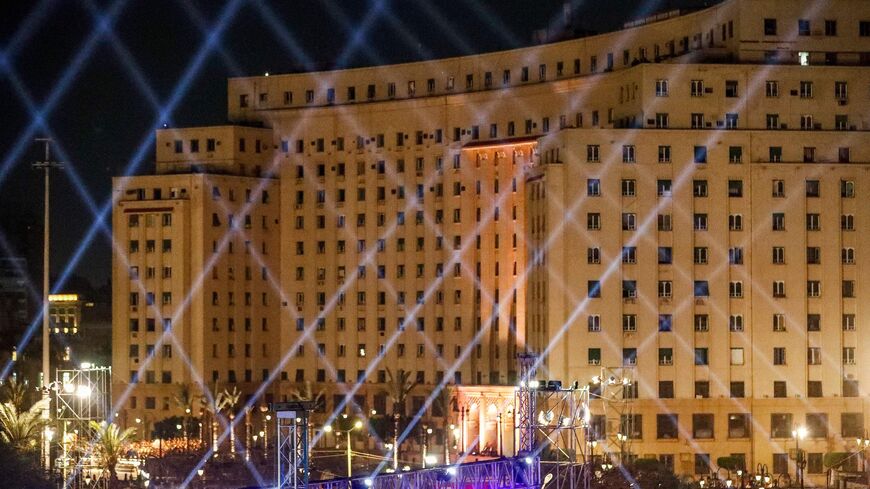 The Mugamma (Complex) administrative government building towering over Cairo's Tahrir Square is lit up on April 3, 2021.
