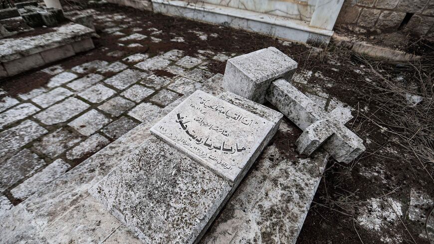 This picture taken on Dec. 27, 2021, shows a view of a broken tombstone at the Roman Catholic monastery area in the town of al-Qanayyah.