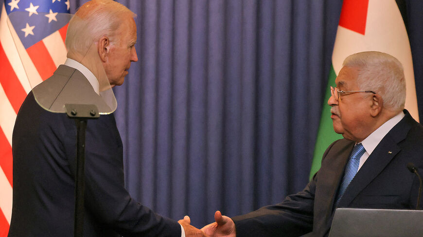 (L to R) US President Joe Biden and Palestinian President Mahmoud Abbas shake hands.
