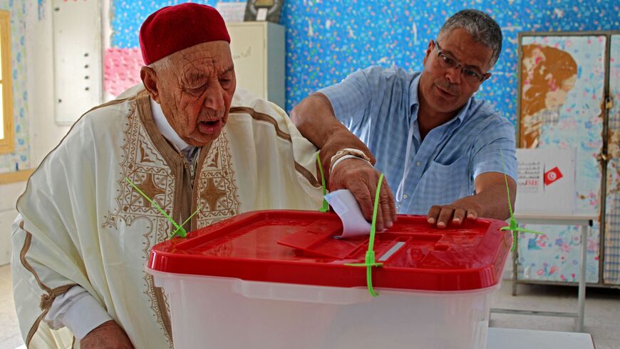 An elderly Tunisian man votes during a referendum on a draft constitution put forward by the country's president.