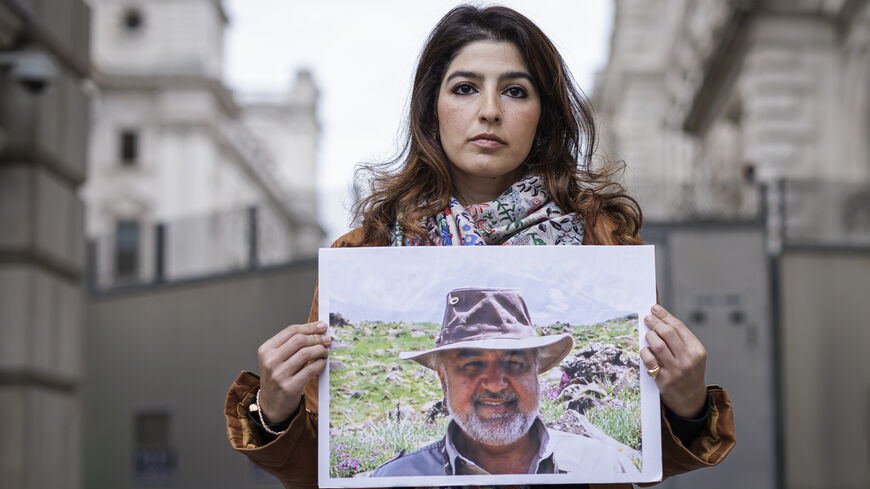 Roxanne Tahbaz holds a photograph of her father, Morad Tahbaz.
