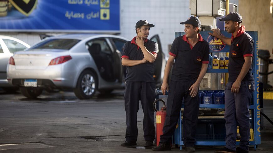 Egyptian workers wait for clients at a petrol station on July 5, 2014, in Cairo as the government drastically raised fuel prices to tackle a bloated subsidy system. 