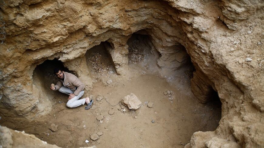Abdul Karim al-Kafarnah, a Palestinian resident of Beit Hanun, collects pottery fragments.