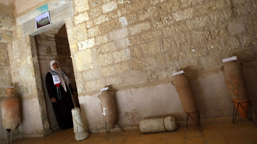 A Palestinian woman stands at a new museum in the ancient Basha Palace, Gaza City, Gaza Strip, Jan. 27, 2010.