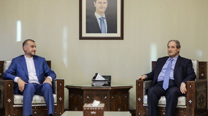 Syrian Foreign Minister Faisal Mekdad (R), meets with his Iranian counterpart Hossein Amir-Abdollahian (C), in the Syrian capital Damascus