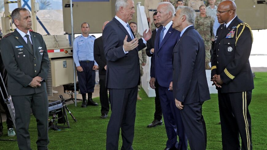 US President Joe Biden (C) speaks with Israeli Defence Minister Benny Gantz (2-L), as caretaker Prime Minister Yair Lapid (2-R) and US Defence Attache in Israel, Brigadier General Shawn A. Harris (R) look on, at Ben Gurion airport