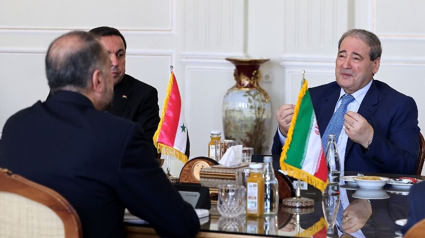 Iran's Foreign Minister Hossein Amir-Abdollahian (L) meets with his Syrian counterpart Faisal Mekdad (2-R) in the capital Tehran, on July 20, 2022