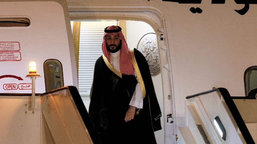 Saudi Crown Prince Mohammed bin Salman disembarks off his aircraft upon arrival at Queen Alia International Airport on the southern outskirts of Jordan's capital Amman on June 21, 2022