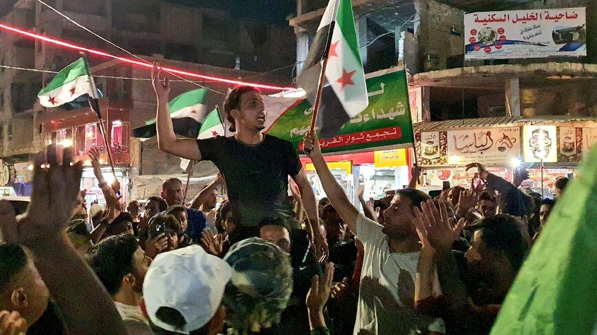 Syrians rally in opposition-held Al-Bab, on the border with Turkey in the northern Aleppo province following statements by the Turkish foreign minister in which he spoke about a possible rapprochement between the Syrian regime and Turkey