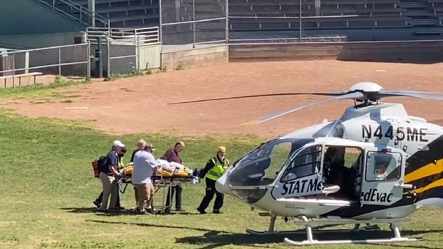 Salman Rushdie is loaded onto a medical evacuation helicopter near the Chautauqua Institution after being stabbed in the neck while speaking on stage in New York state