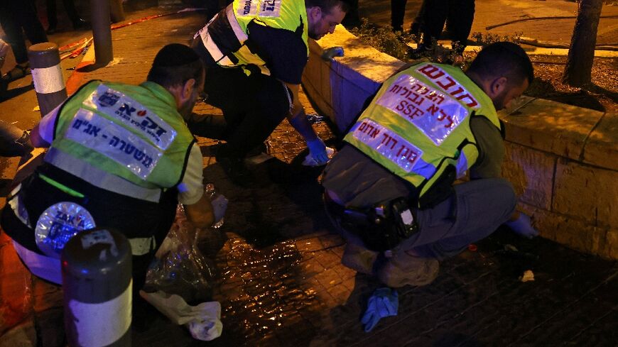 Zaka volunteers, an ultra-Orthodox Jewish emergency response team, clean up blood stains after the attack 