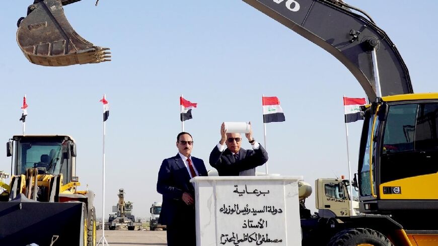A handout image released by the Iraqi premier's press office on its Facebook page shows Prime Minister Mustafa al-Kadhemi (R) during the laying of the foundation stone ceremony of Mosul international airport rehabilitation project