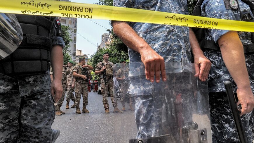 Lebanese security forces stand guard outside a Federal Bank branch in west Beirut