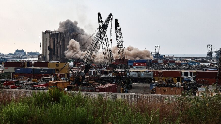 Heavy dust rises as a part of the grain silos in the port of Beirut collapse on August 4, 2022, two years since a giant explosion ripped through the capital