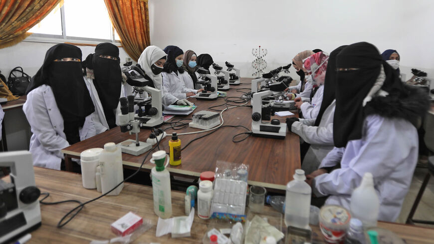 Syrian students from "Aleppo University in Liberated Areas," controlled by the pro-Turkey opposition, sit with microscopes at a laboratory facility, Marea, northern countryside of Aleppo province, Syria, Nov. 26, 2020.